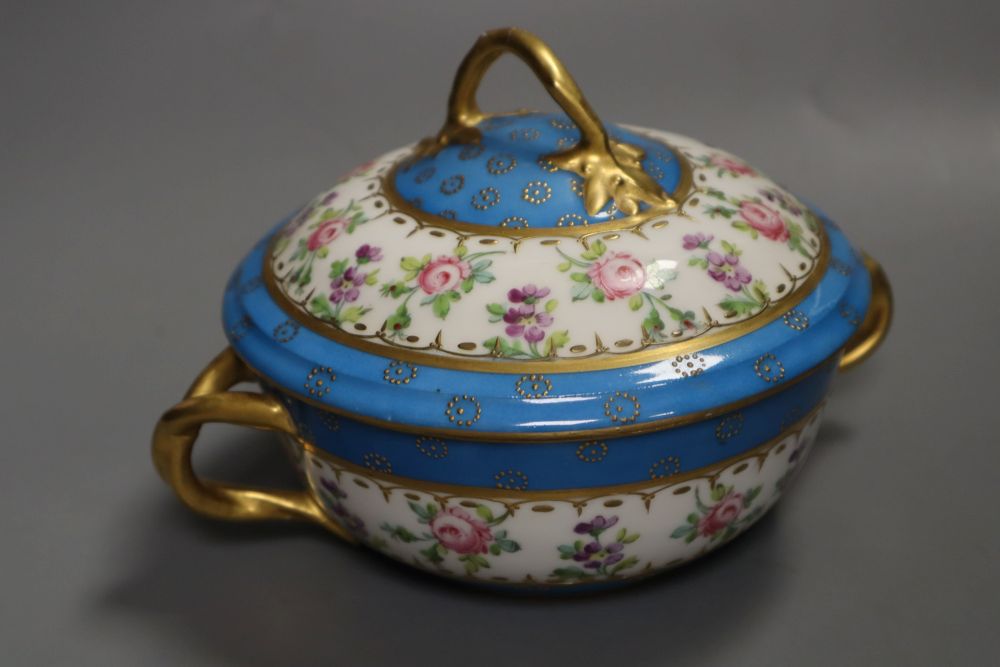 A 19th century Paris porcelain handled bowl and cover painted with roses under turquoise borders, width 19cm height 12cm